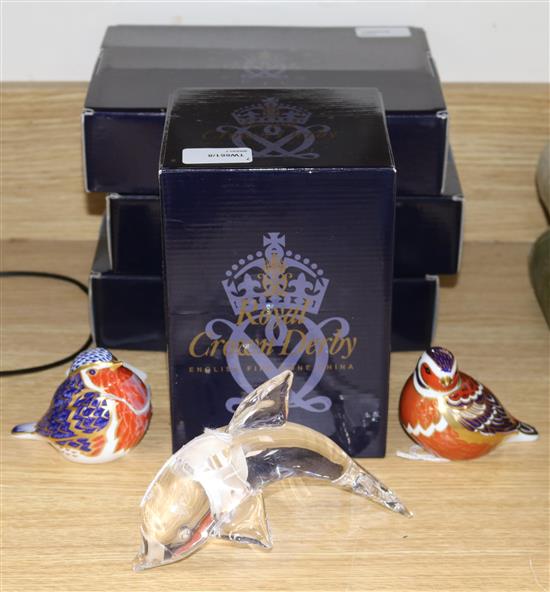 Four boxed Royal Crown Derby paperweights, two unboxed paperweights and a Steuben glass dolphin,